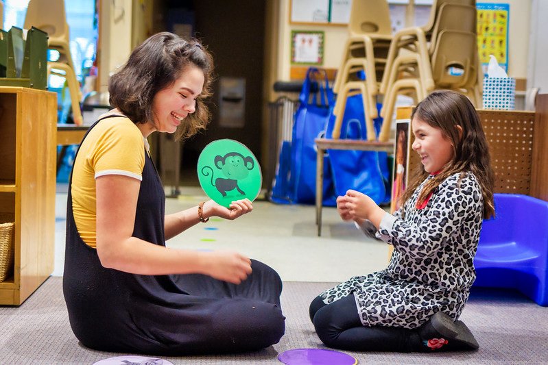 A KidSpirit instructor shares a funny moment with one of her young students.