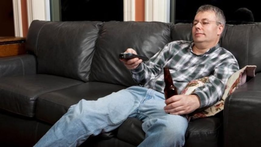 Man on couch watching TV