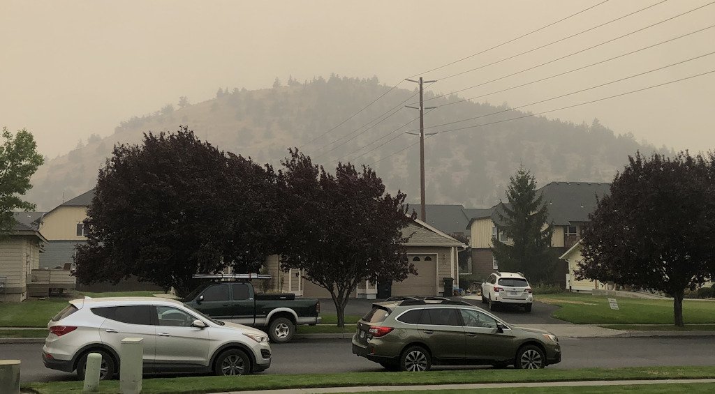 Pilot Butte is visible but gray through the smoky murk in early September 2020