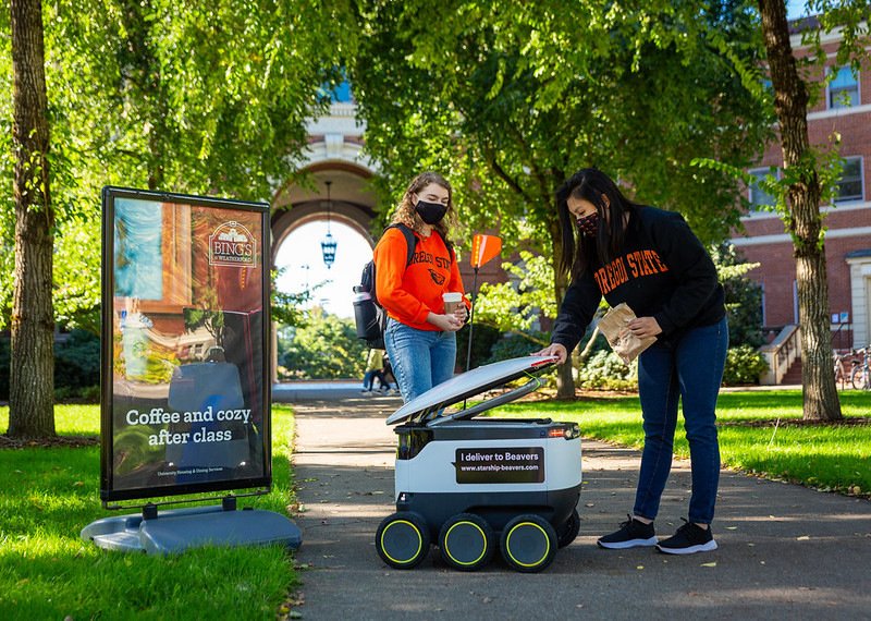 Starship Technologies brought food delivery robots to the Oregon State University campus. Here, OSU students Maria Duong and Isabel Griffin receive a delivery.