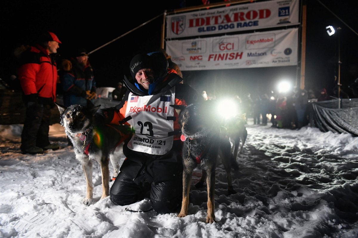 Dallas Seavey poses with his dogs after crossing the finish line to win the Iditarod Trail Sled Dog Race race near Willow, Alaska, early Monday