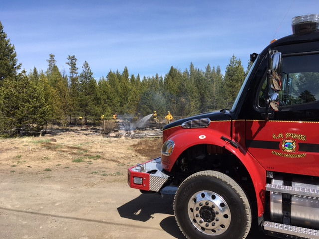 Rekindle burn pile escaped, sparking brush fire Tuesday afternoon