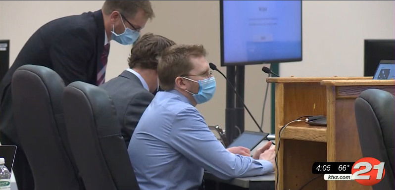 Luke Wirkkala sits by defense attorneys