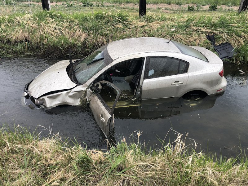 Car was heavily damaged Saturday when it left O'Neil Hwy., rolled and landed in canal