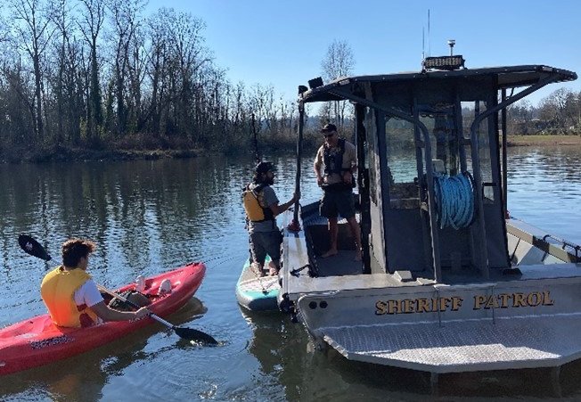 Paddlers interact with law enforcement on the Willamette River