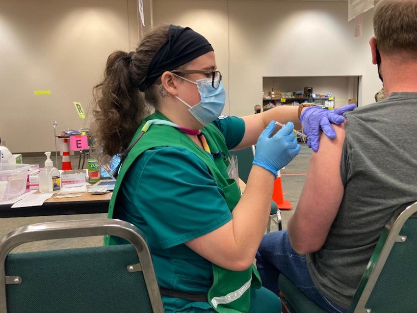 Celia, a COCC nursing student, administers a COVID-19 vaccine at the Deschutes County Fair and Expo Center Mass Vaccination Clinic in June 2021