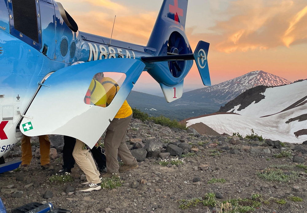 Deschutes County Sheriff's Search and Rescue helps put an injured hiker aboard an Air Link helicopter near Broken Hand on Friday