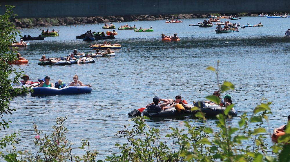 Many flocked to the Deschutes River in Bend on Sunday to try to cool off amid record or near-record temperatures blanketing the region
