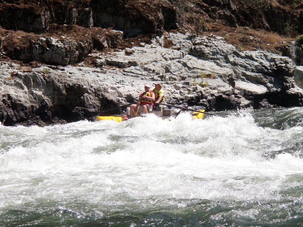 Marine law enforcement practicing swiftwater rescue skills from drift boat on Rogue River