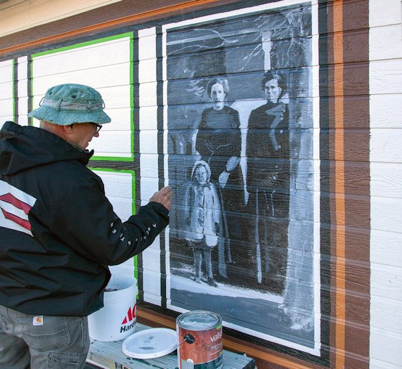 Muralist Steve DeLaitsch began work on Sisters heritage mural in early May