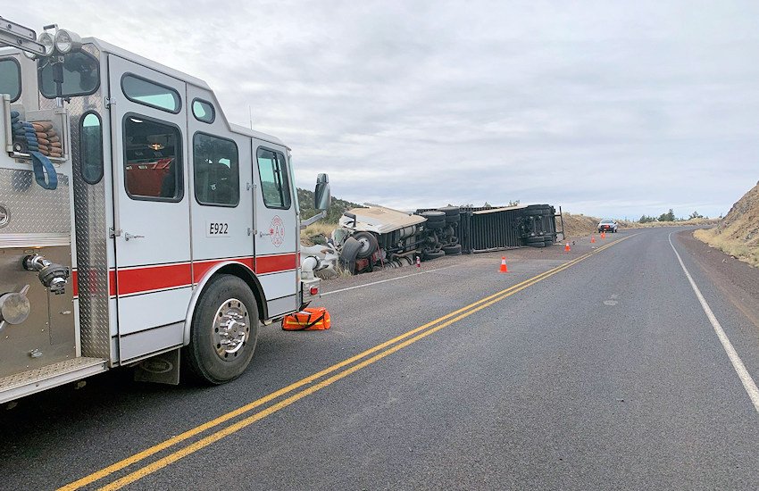 Emergency personnel on scene of semi-truck rollover crash Monday morning on SW George Millican Road