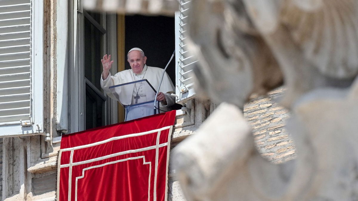 <i>VINCENZO PINTO/AFP via Getty Images</i><br/>Pope Francis waves from a window overlooking St. Peter's Square in the Vatican during the weekly Angelus prayer followed by the recitation of the Regina Coeli on May 9.