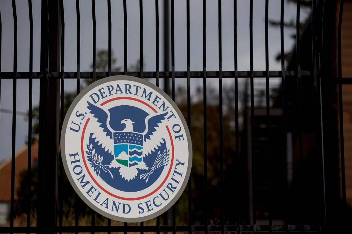 <i>Andrew Harrer/Bloomberg/Getty Images</i><br/>The U.S. Department of Homeland Security (DHS) seal hangs on a fence at the agency's headquarters in Washington