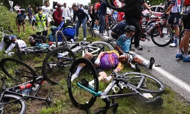 Cyclists Bryan Coquard and Kristian Sbaragli and their teams wait for medical assistance after the crash.