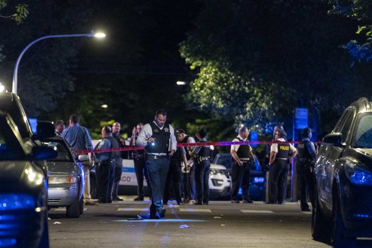 <i>Tyler LaRiviere/Chicago Sun-Times/AP</i><br/>Chicago police respond to the scene of a shooting Sunday