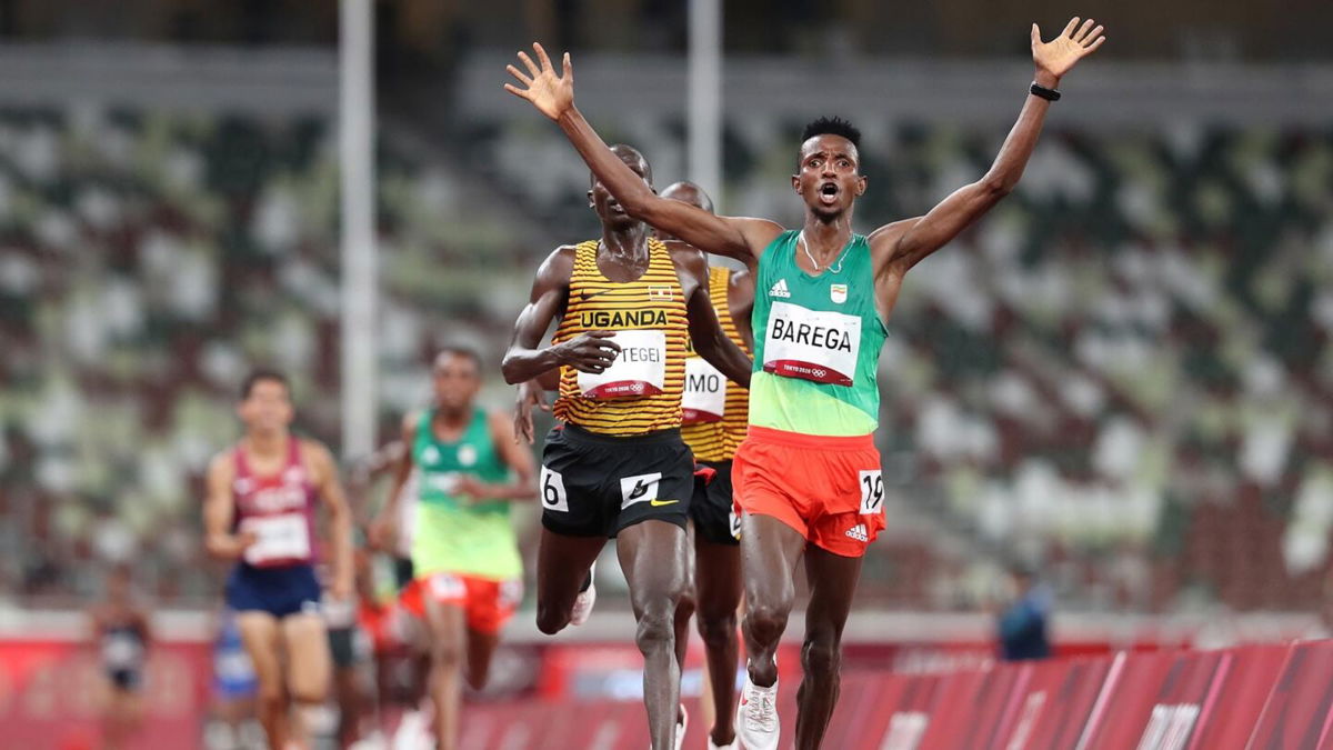 Selemon Barega of Team Ethiopia celebrates winning gold in the Men's 10