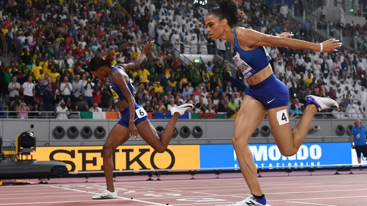 First-placed USA's Dalilah Muhammad (L) and second-placed USA's Sydney Mclaughlin (R) cross the finish line in the Women's 400m Hurdles final at the 2019 IAAF Athletics World Championships
