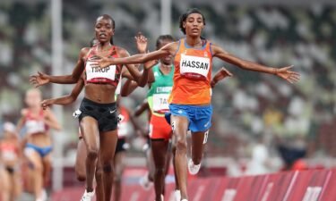 Sifan Hassan of Team Netherlands crosses the finish line first ahead of Agnes Jebet Tirop of Team Kenya in Heat 1 of the Women's 5000m Round 1