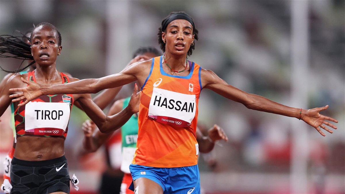 Sifan Hassan of Team Netherlands crosses the finish line first ahead of Agnes Jebet Tirop of Team Kenya in Heat 1 of the Women's 5000m Round 1on day seven of the Tokyo 2020 Olympic Games at Olympic Stadium on July 30