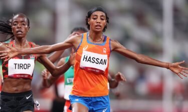 Sifan Hassan of Team Netherlands crosses the finish line first ahead of Agnes Jebet Tirop of Team Kenya in Heat 1 of the Women's 5000m Round 1on day seven of the Tokyo 2020 Olympic Games at Olympic Stadium on July 30
