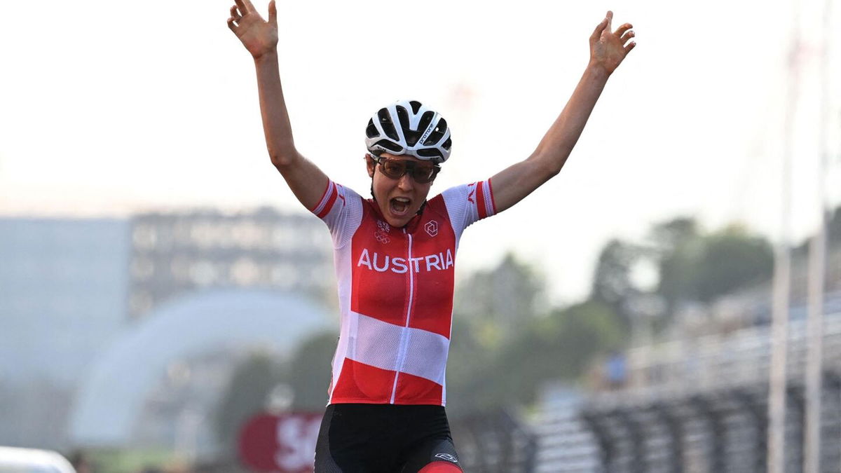 Austria's Anna Kiesenhofer celebrates as she crosses the finish line