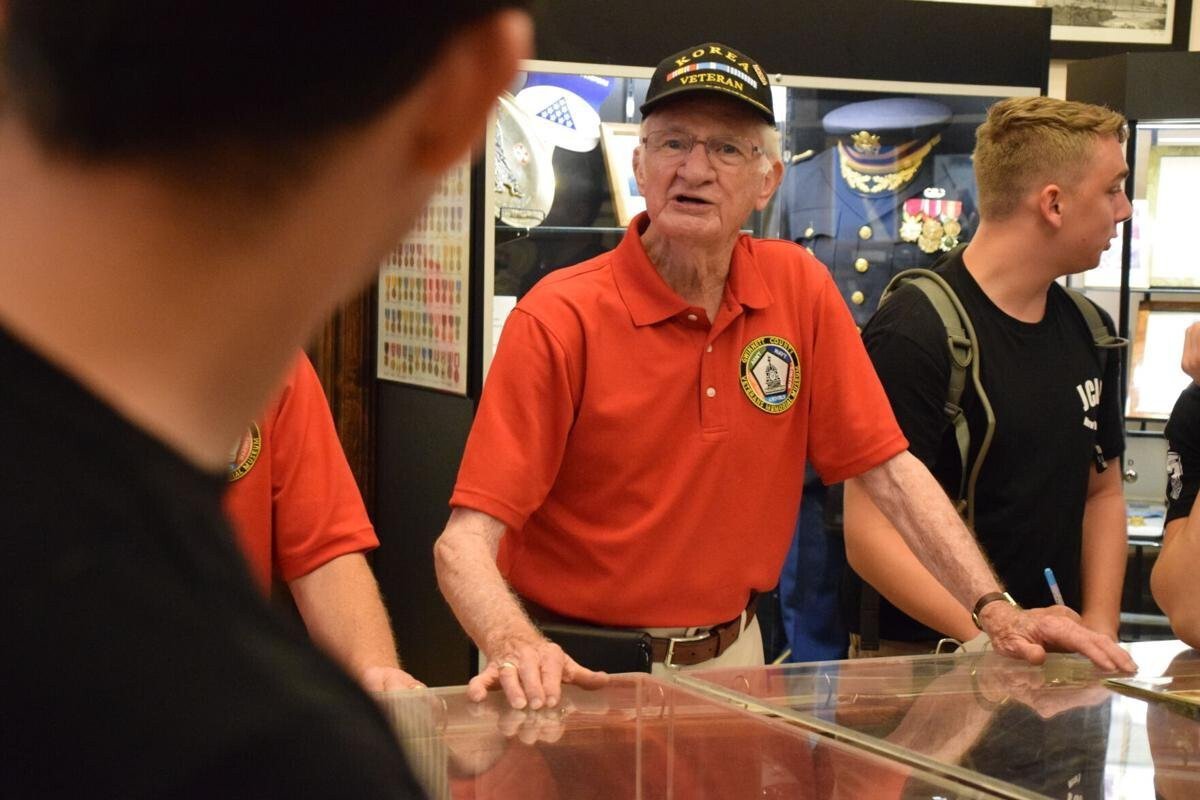 <i>Gwinnett Daily Post</i><br/>Gwinnett Veterans Memorial Museum volunteer Frank Dermer talks to Jackson County High School and East Jackson High School JROTC students during their recent visit to the museum.
