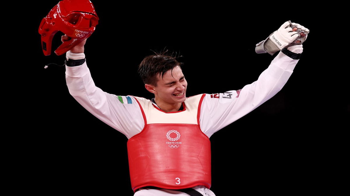 Ulugbek Rashitov celebrates winning a gold medal in taekwondo