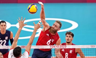 U.S. middle blocker Mitchell Stahl skies for a kill Wednesday against Tunisia at the Tokyo Olympics.