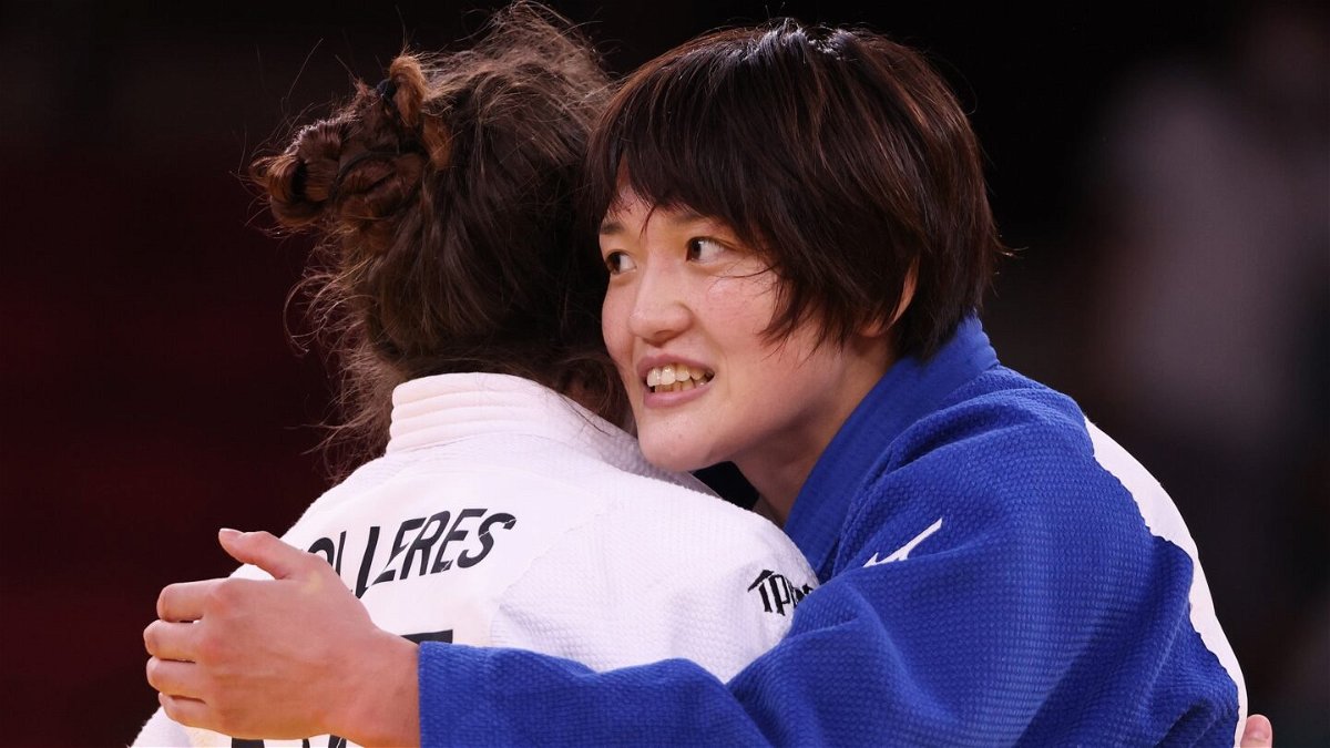 Japan's Chizuru Arai smiles while hugging Michaela Polleres of Austria after the Women’s Judo 70kg Final
