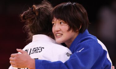 Japan's Chizuru Arai smiles while hugging Michaela Polleres of Austria after the Women’s Judo 70kg Final