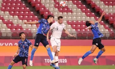 Chris Wood of New Zealand competes for a header with Takehiro Tomiyasu of Japan