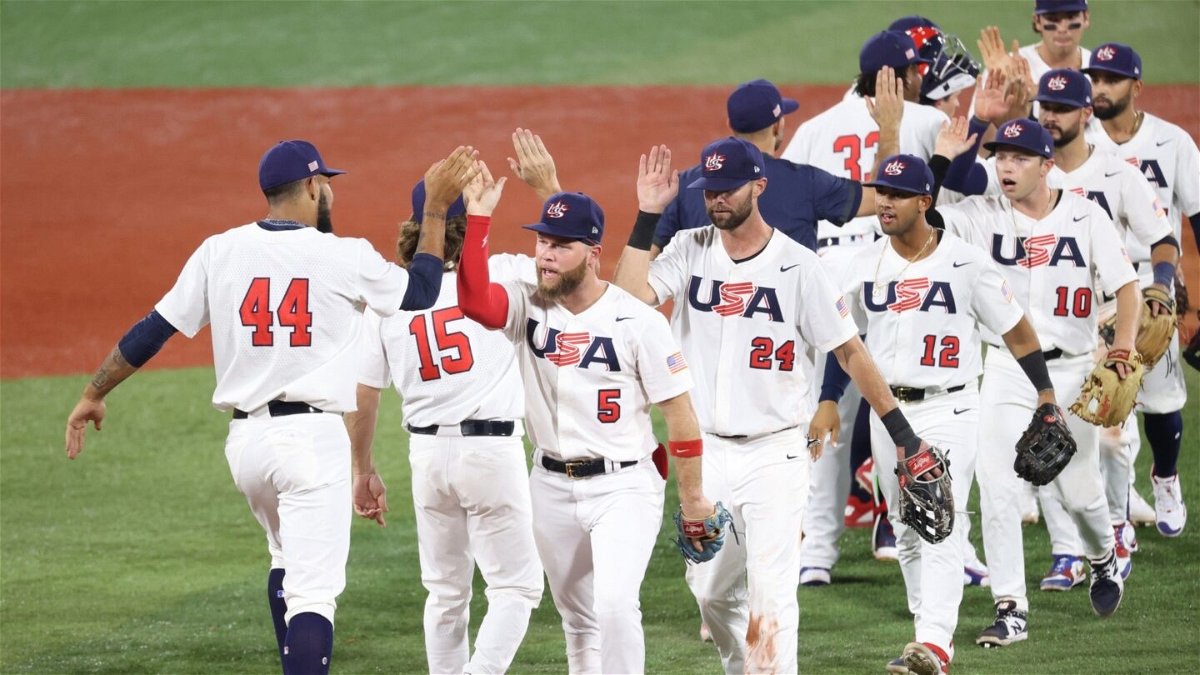 Simeon Woods Richardson #44 and Eric Filia #5 of Team United States celebrate with teammates after winning 4-1 during the baseball opening round Group B game against South Korea.