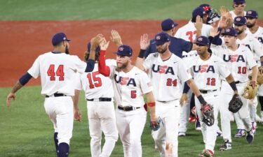 Simeon Woods Richardson #44 and Eric Filia #5 of Team United States celebrate with teammates after winning 4-1 during the baseball opening round Group B game against South Korea.