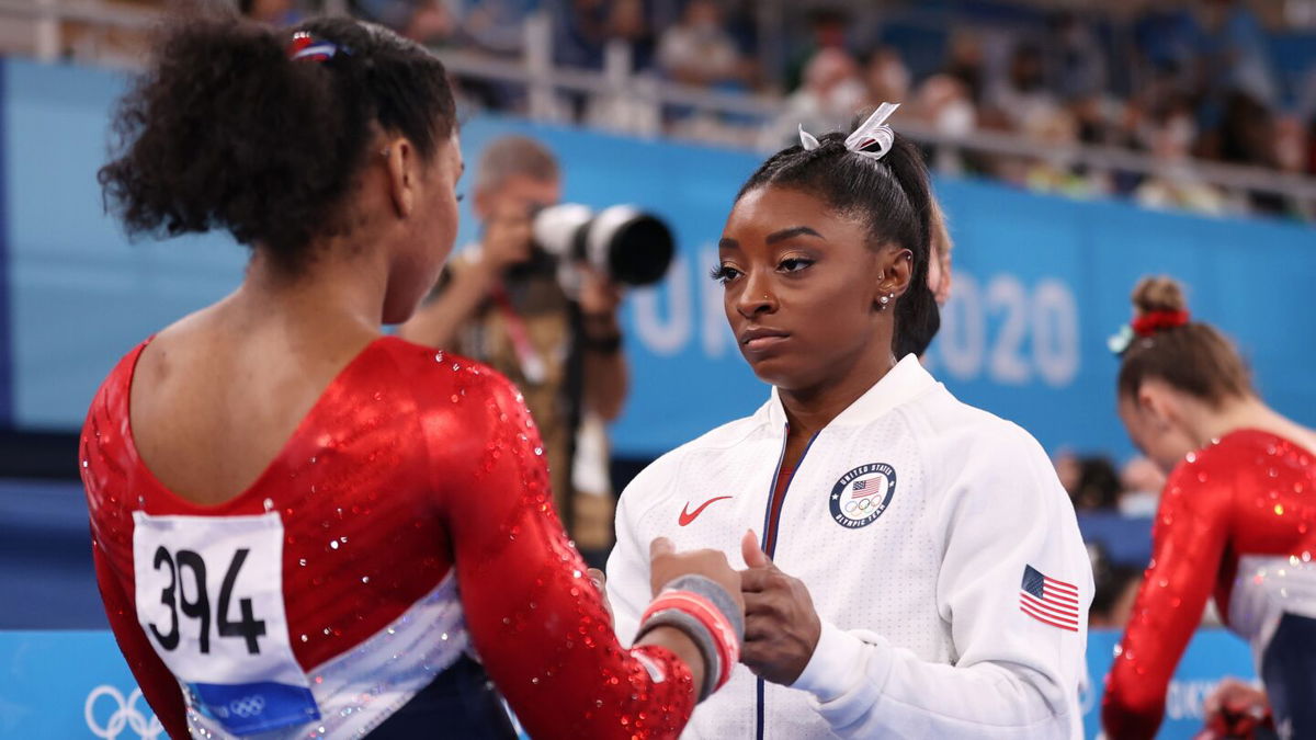 Simone Biles encourages teammate Jordan Chiles during the team final of the women's artistic gymnastics competition in Tokyo