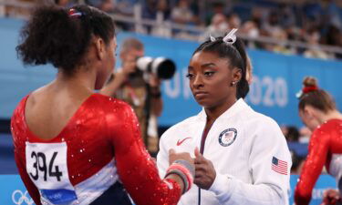 Simone Biles encourages teammate Jordan Chiles during the team final of the women's artistic gymnastics competition in Tokyo