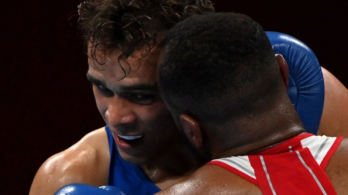 Morocco's Youness Baalla (red) and New Zealand's David Nyika fight during their men's heavy (81-91kg) preliminaries round of 16 boxing match during the Tokyo 2020 Olympic Games at the Kokugikan Arena in Tokyo on July 27