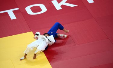 France's Amandine Buchard (white) competes with Switzerland's Fabienne Kocher during their judo women's -52kg semifinal A bout during the Tokyo 2020 Olympic Games at the Nippon Budokan in Tokyo on July 25