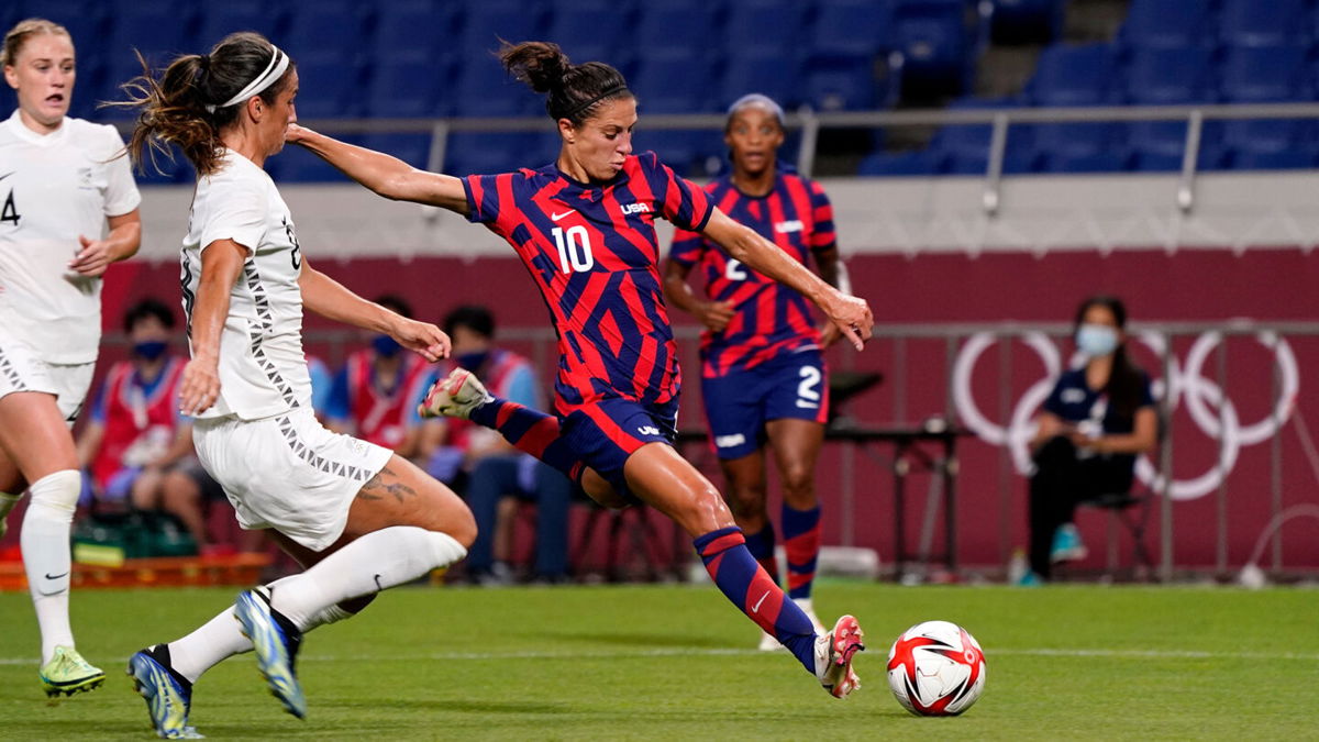 Carli Lloyd about to hit a soccer ball