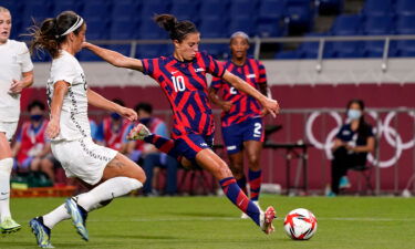 Carli Lloyd about to hit a soccer ball
