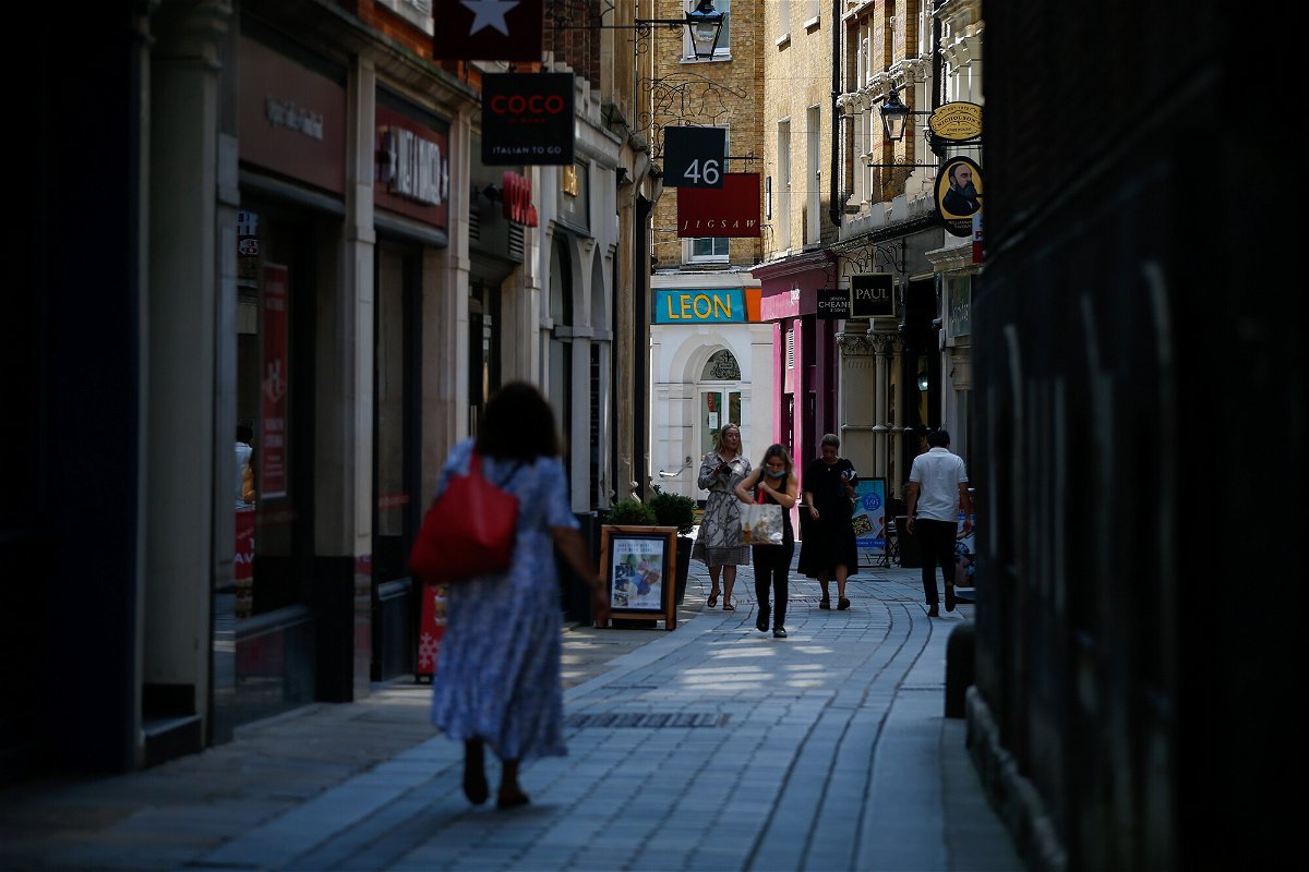 <i>Hollie Adams/Bloomberg/Getty Images</i><br/>Pedestrians walk on Bow Street in the City of London on July 19. The UK government's decision to lift almost all remaining coronavirus restrictions in England was expected to deliver a windfall for businesses that have been hampered by social distancing rules.