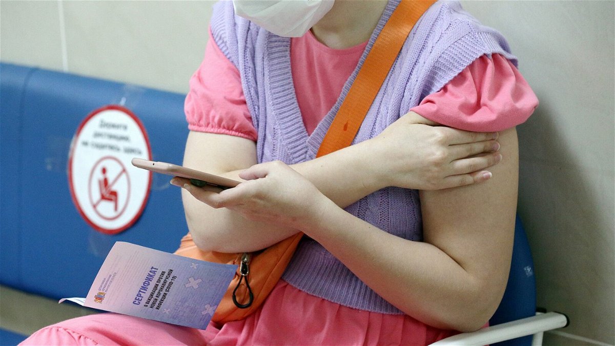 <i>Vladimir Smirnov/TASS/Getty Images</i><br/>A woman is pictured with a vaccination certificate after receiving a shot in the city of Ivanovo on June 18.