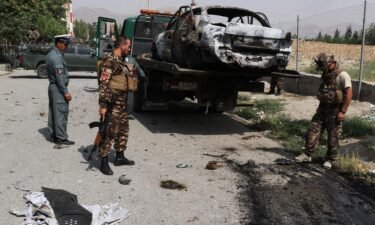 Afghan security forces inspect the scene after rockets were launched near the presidential palace in Kabul