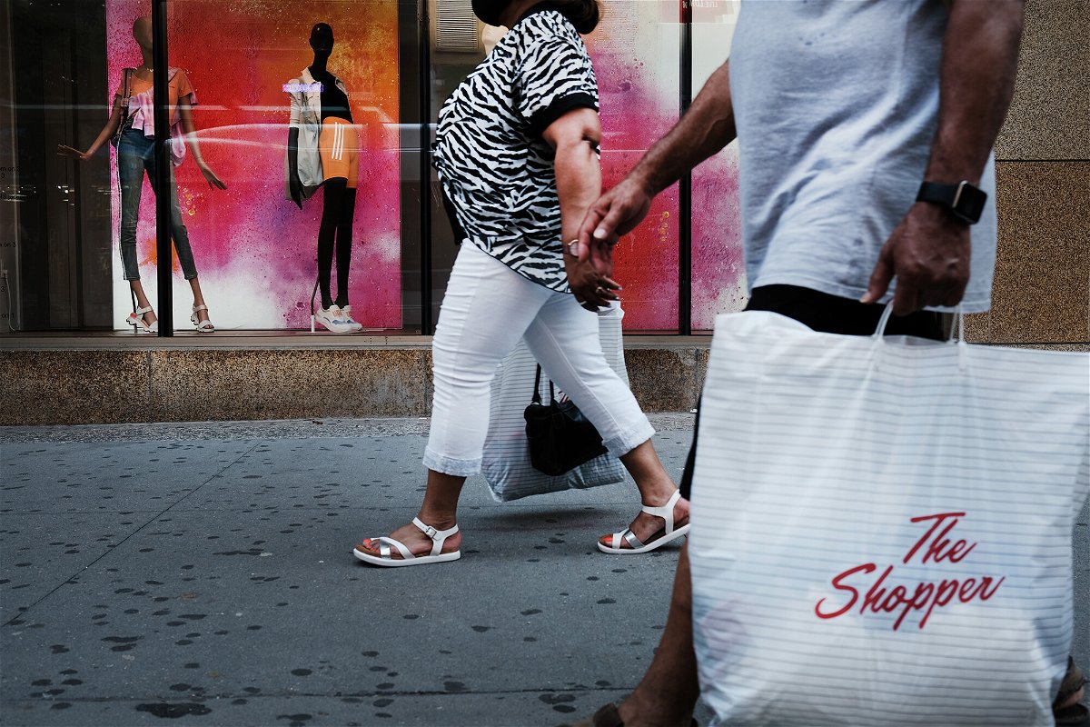 <i>Spencer Platt/Getty Images</i><br/>People walk through a shopping district in Brooklyn on July 16 in New York City. As demand for goods remains strong