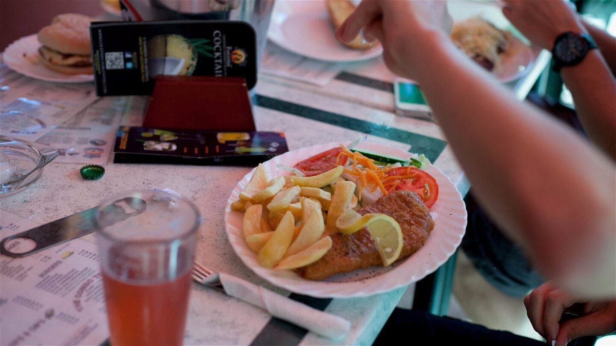 <i>Pablo Blazquez Dominguez/Getty Images</i><br/>A man adds salt to his fish and chips in a British restaurant in Benidorm