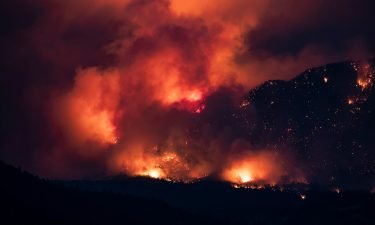 A wildfire burns on the side of a mountain in Lytton