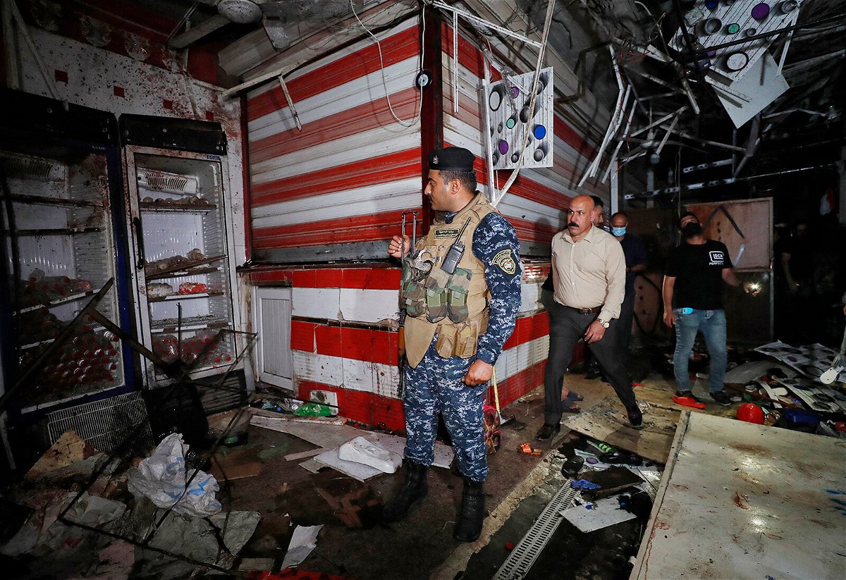 <i>Ahmad Al-Rubaye/AFP/Getty Images</i><br/>Iraqis inspect the site of an explosion at a popular market in eastern Baghdad on July 19.