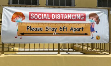A social distancing sign hangs at Morris K. Hamasaki Elementary School in Los Angeles on July 1. New Covid-19 cases among children are back on the rise after months of declines