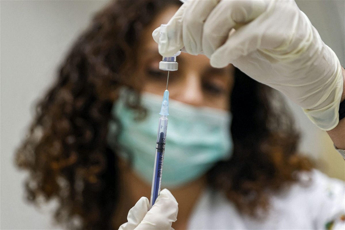 <i>JACK GUEZ/AFP/AFP via Getty Images</i><br/>A medic prepares a dose of the Pfizer-BioNTech Covid-19 vaccine at the Clalit Healthcare Services in Holon