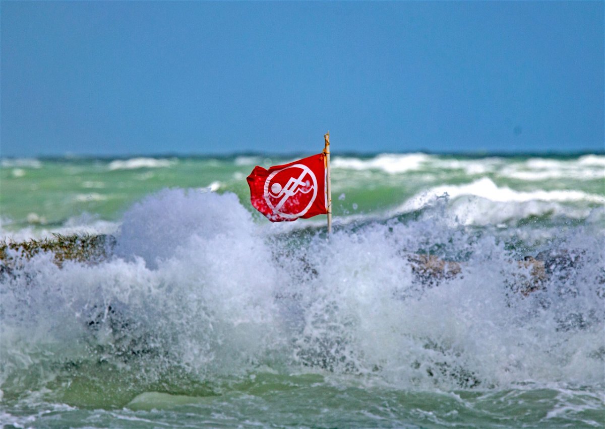 <i>David Santiago/Miami Herald/TNS/Sipa</i><br/>Waves crash around a no-swimming flag at Haulover Park beach in Miami Beach
