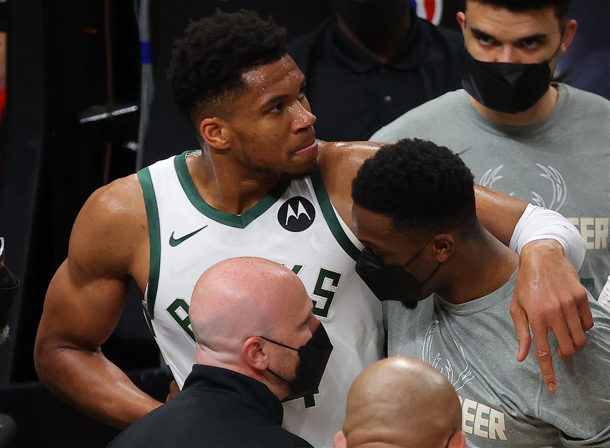 <i>Kevin C. Cox/Getty Images North America/Getty Images</i><br/>Giannis Antetokounmpo is helped off the court after being injured during Game 4 of the Eastern Conference Finals.